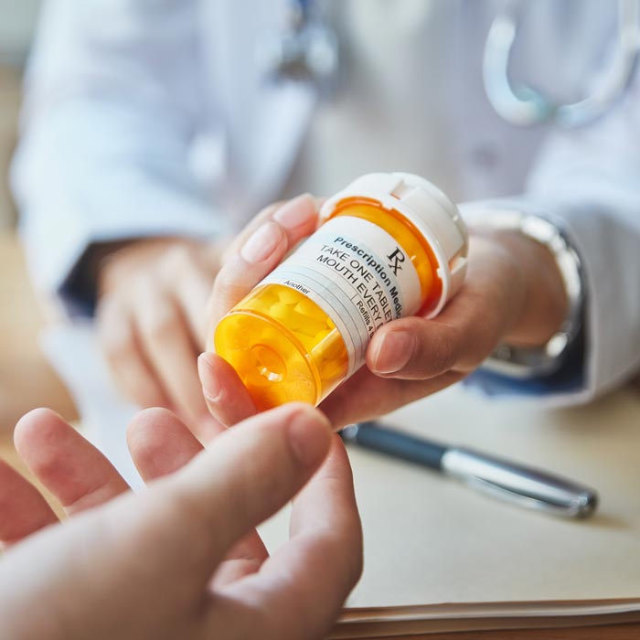 pharmacist handing over bottle