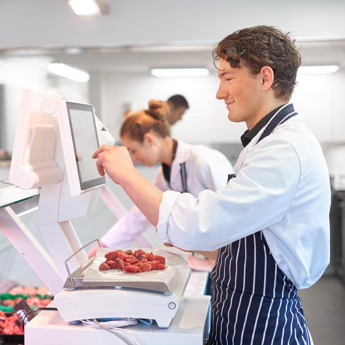 butcher weighing meat on scale